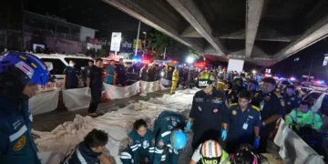 Emergency responders work at the scene of a deadly pub fire in Bangkok. - AP Photo/Sakchai Lalit