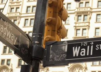 Street signs marking the intersection of Broadway and Wall Street in New York City's Financial District, a landmark associated with the U.S. financial markets.