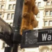 Street signs marking the intersection of Broadway and Wall Street in New York City's Financial District, a landmark associated with the U.S. financial markets.