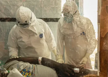 Healthcare workers at an Ebola treatment center during Congo clinical trial - AP Photo/Moses Sawasawa, File