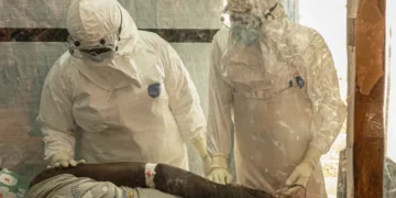 Healthcare workers at an Ebola treatment center during Congo clinical trial - AP Photo/Moses Sawasawa, File