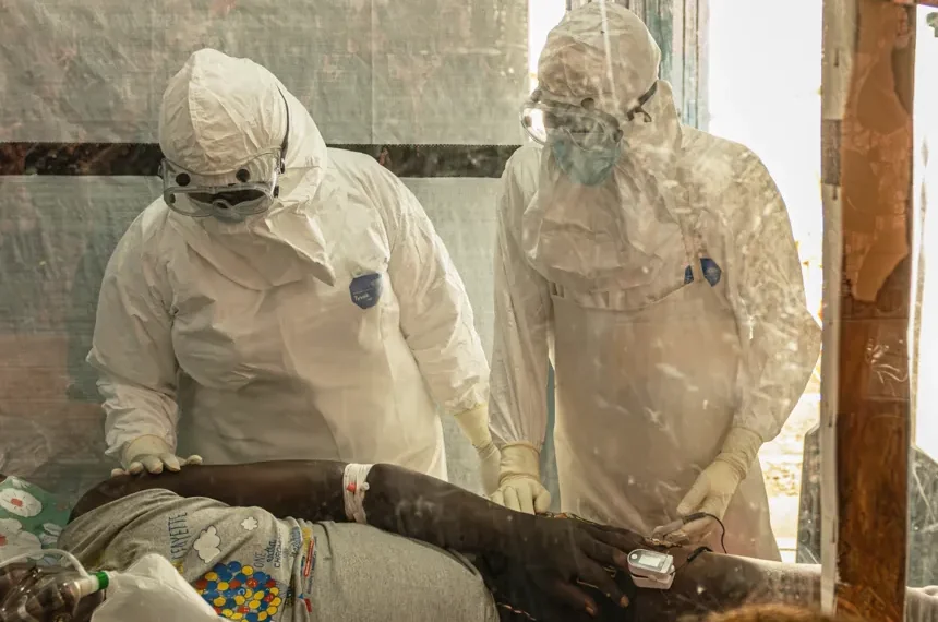 Healthcare workers at an Ebola treatment center during Congo clinical trial - AP Photo/Moses Sawasawa, File