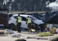 Emergency responders work at the scene after a vehicle crashed into an open-air market in Viña del Mar, Chile. - Sebastian Cisterna/ATON via AP