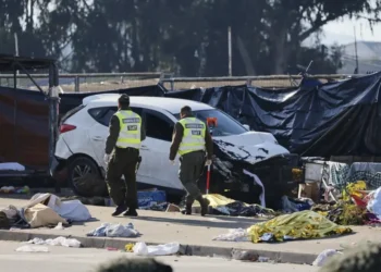 Emergency responders work at the scene after a vehicle crashed into an open-air market in Viña del Mar, Chile. - Sebastian Cisterna/ATON via AP