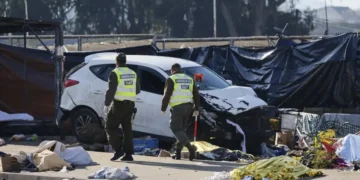 Emergency responders work at the scene after a vehicle crashed into an open-air market in Viña del Mar, Chile. - Sebastian Cisterna/ATON via AP