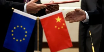 Chinese and European Union officials discuss trade cooperation and economic relations. - AP Photo/Andy Wong, File