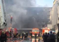 Smoke rises from a shoe factory after a deadly fire in Jinjiang, Fujian. - Zheng Liang/Xinhua via AP