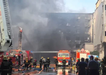 Smoke rises from a shoe factory after a deadly fire in Jinjiang, Fujian. - Zheng Liang/Xinhua via AP
