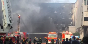 Smoke rises from a shoe factory after a deadly fire in Jinjiang, Fujian. - Zheng Liang/Xinhua via AP