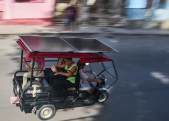 Solar-powered electric tricycles travel through the streets of Havana, Cuba. - AP Photo/Ramon Espinosa