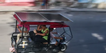 Solar-powered electric tricycles travel through the streets of Havana, Cuba. - AP Photo/Ramon Espinosa