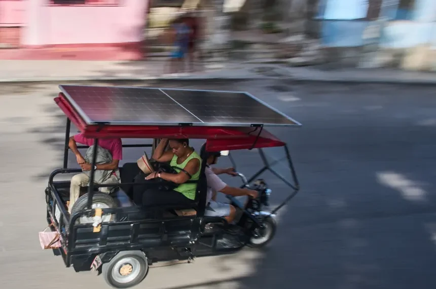 Solar-powered electric tricycles travel through the streets of Havana, Cuba. - AP Photo/Ramon Espinosa