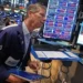 Wall Street traders monitor markets as the Dow reaches a record high. - AP Photo/Richard Drew