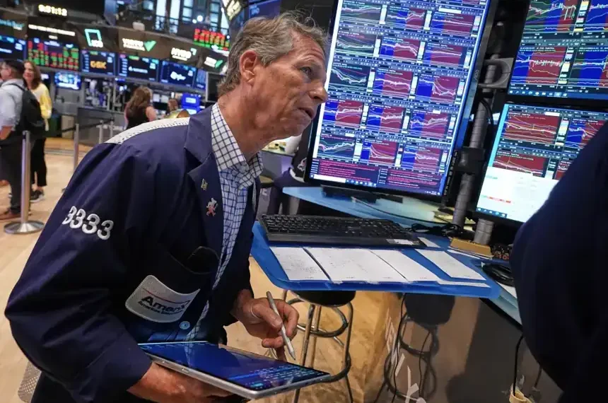 Wall Street traders monitor markets as the Dow reaches a record high. - AP Photo/Richard Drew