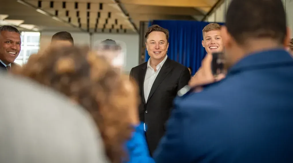 Elon Musk poses with U.S. Air Force Academy cadets during a visit to the academy in Colorado, alongside military personnel and academy leadership.