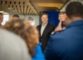 Elon Musk poses with U.S. Air Force Academy cadets during a visit to the academy in Colorado, alongside military personnel and academy leadership.