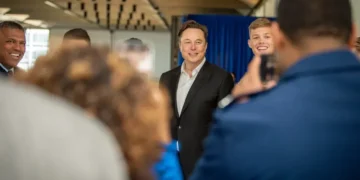 Elon Musk poses with U.S. Air Force Academy cadets during a visit to the academy in Colorado, alongside military personnel and academy leadership.