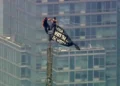 Two climbers atop the Empire State Building antenna in New York City - WABC-TV via AP