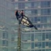 Two climbers atop the Empire State Building antenna in New York City - WABC-TV via AP