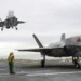 Two F-35B Lightning II stealth fighter aircraft land on the flight deck of the USS America during operational testing in the Pacific Ocean.