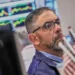 Electronic market boards display mixed global stock index performances and AI shares. - AP Photo/Richard Drew