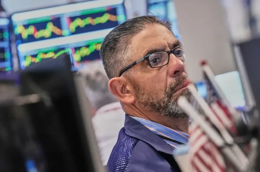 Electronic market boards display mixed global stock index performances and AI shares. - AP Photo/Richard Drew