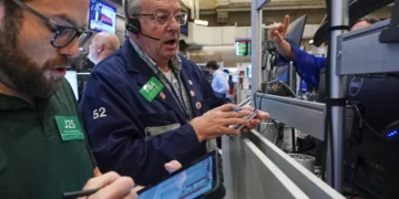 Oil price chart and global stock market screens after Iran ceasefire uncertainty - AP Photo/Richard Drew