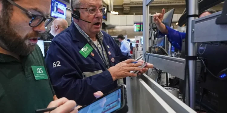 Oil price chart and global stock market screens after Iran ceasefire uncertainty - AP Photo/Richard Drew