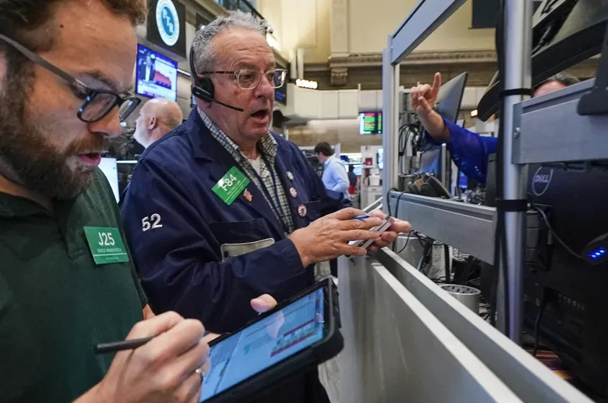 Oil price chart and global stock market screens after Iran ceasefire uncertainty - AP Photo/Richard Drew