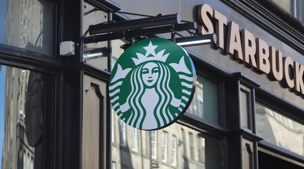 Exterior of a Starbucks coffee shop on the Royal Mile in Edinburgh, Scotland, displaying the company's storefront and signage.