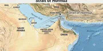 Relief map of the Strait of Hormuz showing Iran, Oman, the United Arab Emirates, the Persian Gulf, the Gulf of Oman, Bandar Abbas, and the international shipping lanes through the strategic waterway.