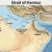 Relief map of the Strait of Hormuz showing Iran, Oman, the United Arab Emirates, the Persian Gulf, the Gulf of Oman, Bandar Abbas, and the international shipping lanes through the strategic waterway.