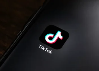 TikTok app icon displayed on the home screen of a smartphone for editorial illustration of the social media platform.