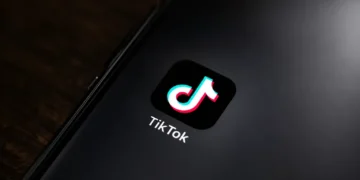 TikTok app icon displayed on the home screen of a smartphone for editorial illustration of the social media platform.