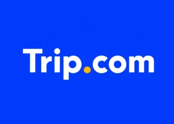 Trip.com app logo displayed on the home screen of a smartphone for editorial illustration of the online travel platform.