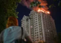 Emergency responders near damaged residential buildings after overnight strikes in Kyiv - AP Photo/Danylo Antoniuk