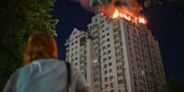Emergency responders near damaged residential buildings after overnight strikes in Kyiv - AP Photo/Danylo Antoniuk