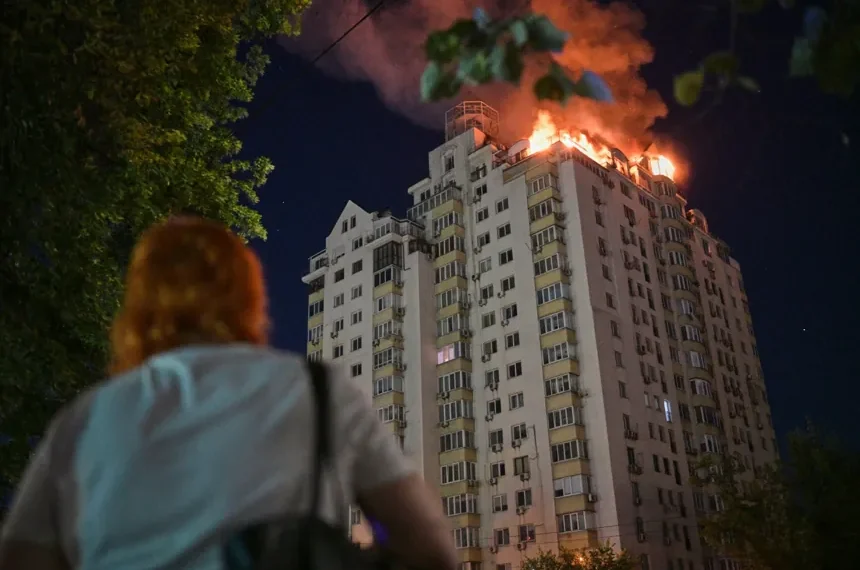 Emergency responders near damaged residential buildings after overnight strikes in Kyiv - AP Photo/Danylo Antoniuk