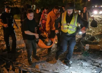 Emergency workers search damaged buildings after Russian missile strikes in Kyiv. - AP Photo/Danylo Antoniuk