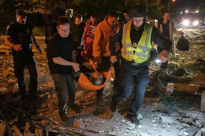 Emergency workers search damaged buildings after Russian missile strikes in Kyiv. - AP Photo/Danylo Antoniuk