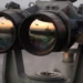 A pair of binoculars sits on the signal bridge of USS Harry S. Truman as an MH-60S Seahawk conducts a replenishment mission at sea.