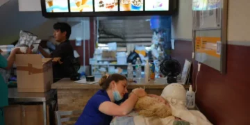 Veterinarians treat a rescued dog inside a McDonald's after Venezuela's earthquake. - AP Photo/Matias Delacroix