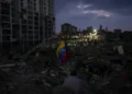 Residents search through earthquake rubble in La Guaira, Venezuela. - AP Photo/Matias Delacroix
