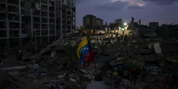 Residents search through earthquake rubble in La Guaira, Venezuela. - AP Photo/Matias Delacroix