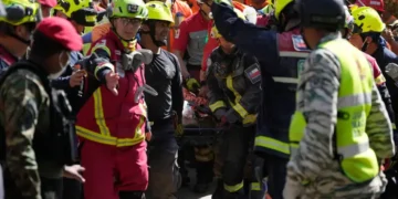 Rescue teams carry survivor from collapsed shopping center in Venezuela. - AP Photo/Fernando Vergara