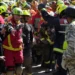 Rescue teams carry survivor from collapsed shopping center in Venezuela. - AP Photo/Fernando Vergara