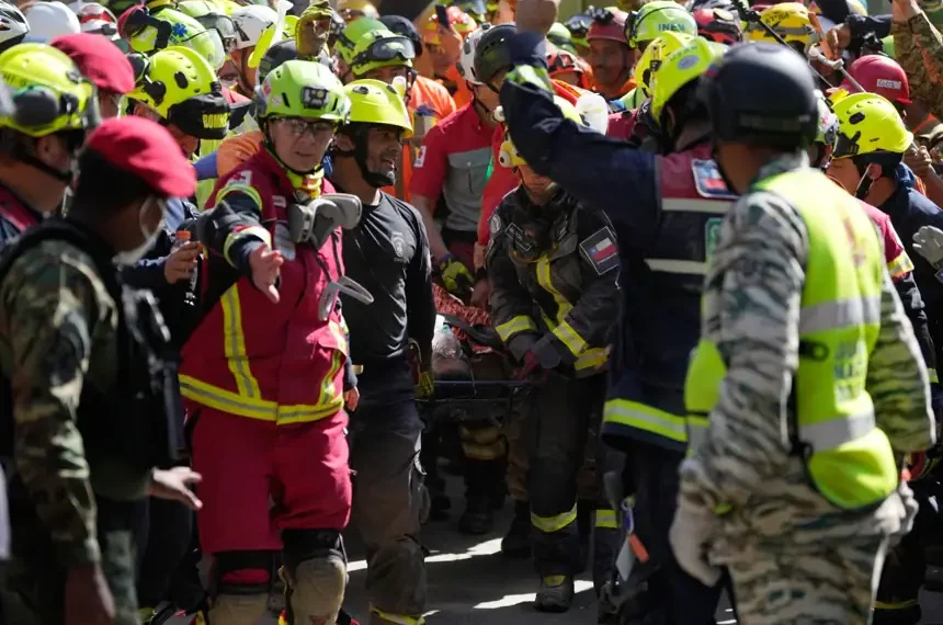 Rescue teams carry survivor from collapsed shopping center in Venezuela. - AP Photo/Fernando Vergara