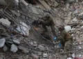 Rescue workers search collapsed buildings after devastating earthquakes in La Guaira - AP Photo/Ariana Cubillos