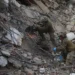 Rescue workers search collapsed buildings after devastating earthquakes in La Guaira - AP Photo/Ariana Cubillos