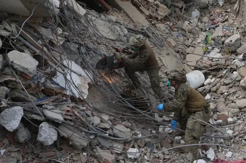 Rescue workers search collapsed buildings after devastating earthquakes in La Guaira - AP Photo/Ariana Cubillos